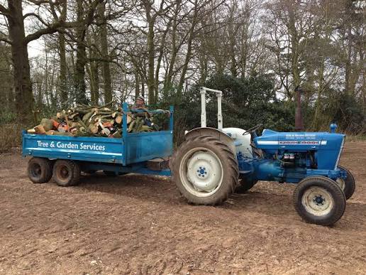 Tree & Garden Services tractor and trailer loaded with cut logs