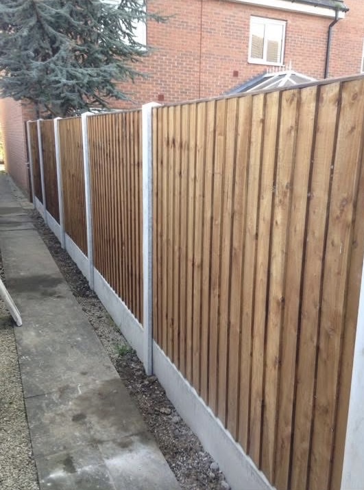 New close-board timber fence panels with concrete posts and gravel boards